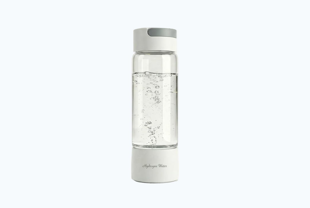 Clear water bottle with white base and cap on a white background