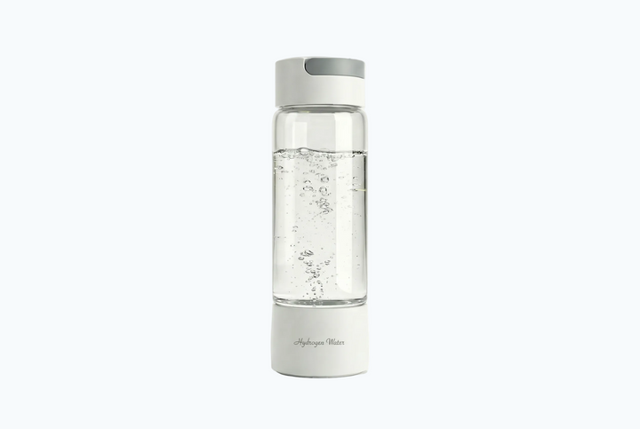 Clear water bottle with white base and cap on a white background